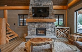 living area with fireplace in log cabin kit