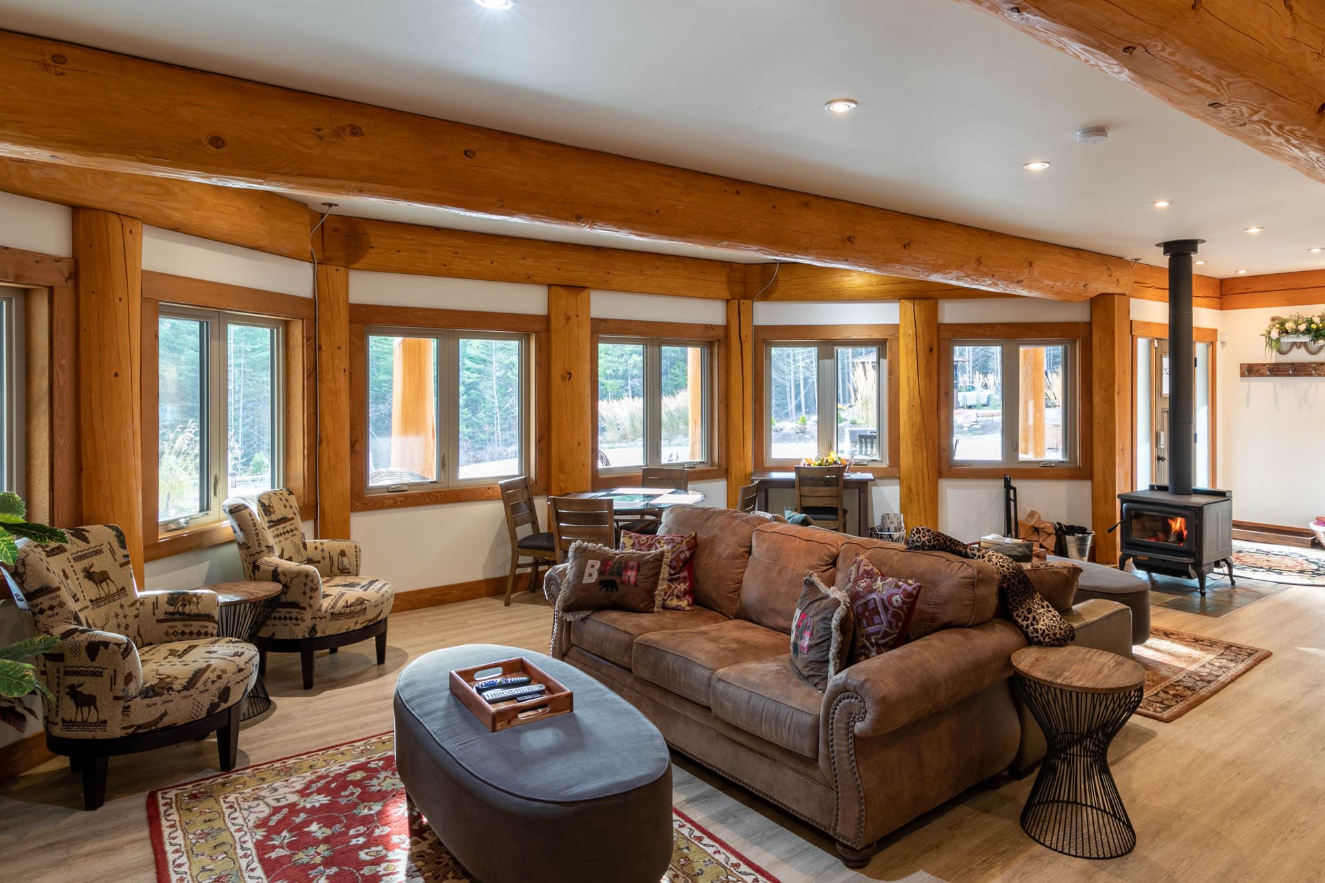 Timber Frame post and beam log home living area with fireplace.
