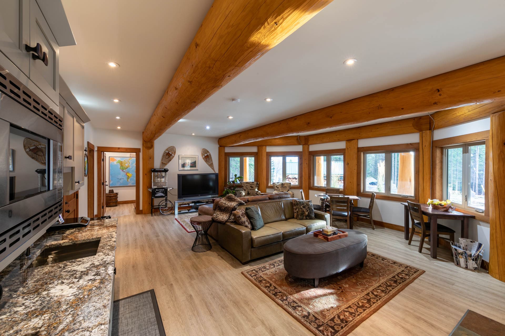 Post and beam log home living area and kitchen. BC log home builders.