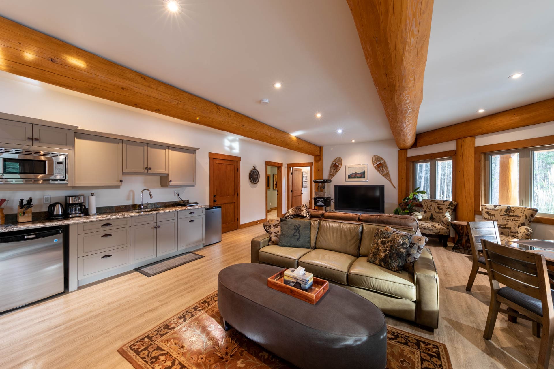 post and beam log home in BC interior view of kitchen and living area.