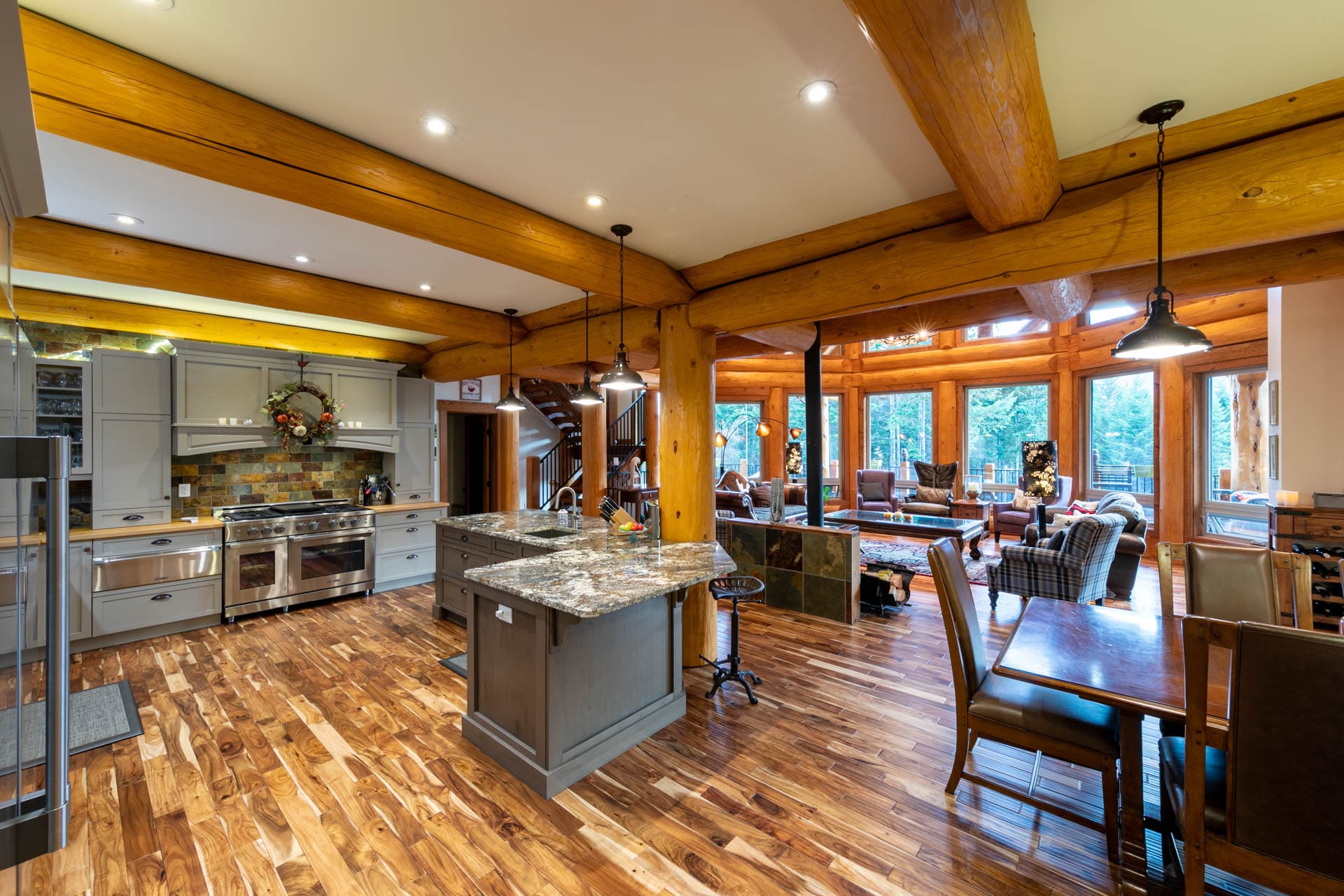 Kitchen and living area of post and beam log home custom built.