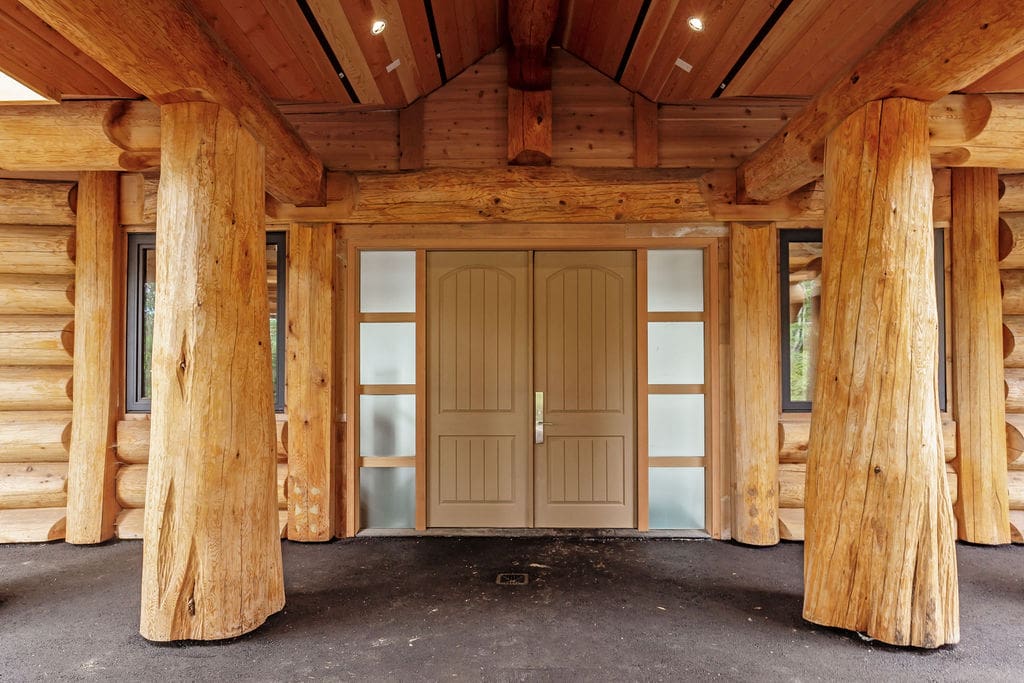BC Custom-built post and beam log home exterior entrance.