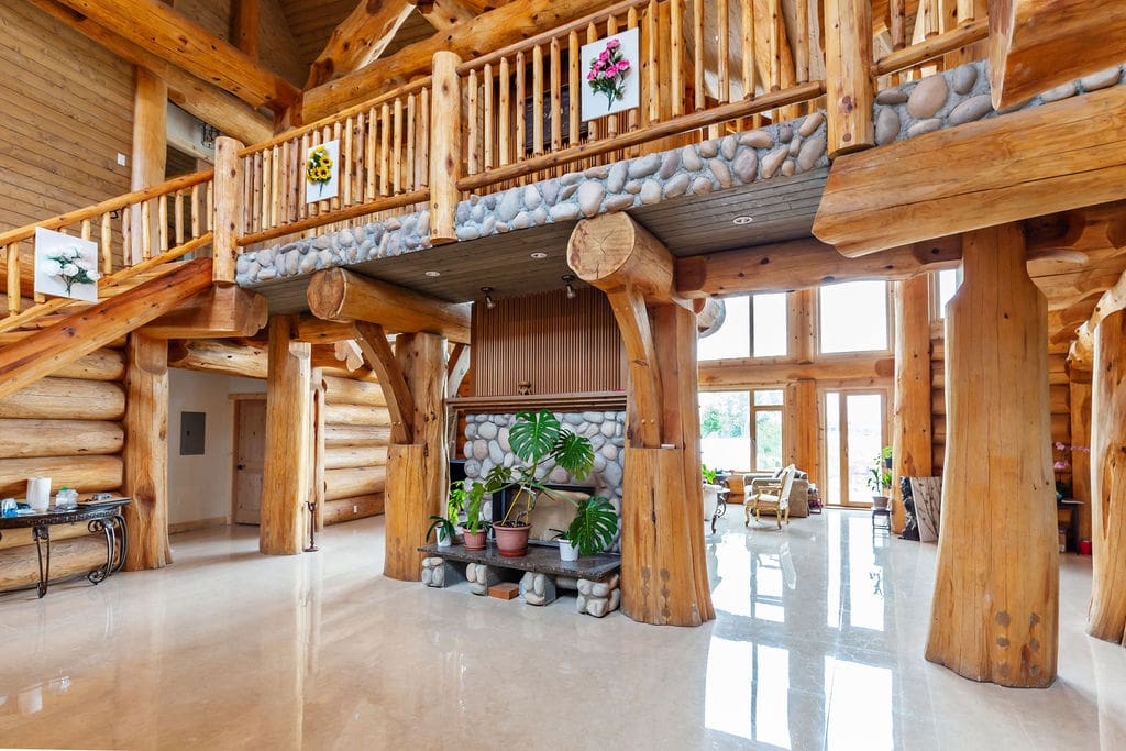 Post and beam log home, interior living space with log railings.