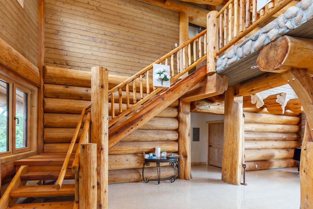 Log stairs in custom build post and beam log home.