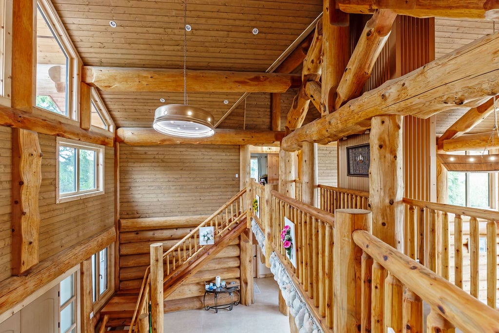 Custom-built Log Stairs in a post and bean log home.