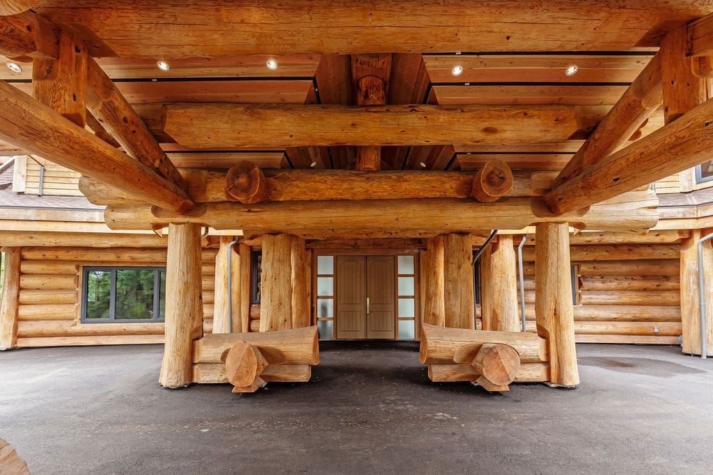Log post and beam home exterior with piece en piece walls built by BC Log Home Builders.